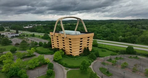 Pull back ascending flight viewing a building built to look like a basket Stock Footage 335671312