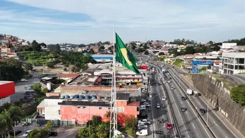Pull back from Brazilian flag mast over Cotia rooftops, Raposo Tavares Vídeo Stock 342646446