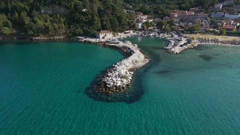 Pull back from the breakwater to Skala Potamia and Golden Beach Stock Footage 347176989