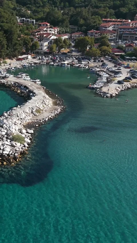 Pull back from breakwater to Skala Potamia and Golden Beach, vertical Stock Footage 347178826