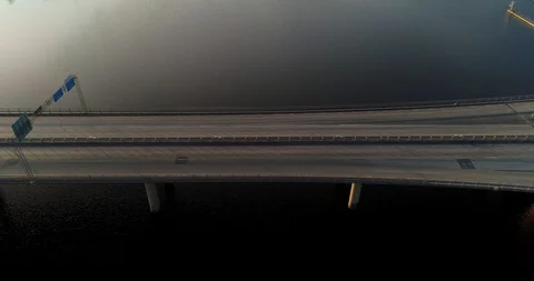 Pull back from a bridge with morning traffic and morning sun Stock Footage 124007288