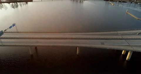 Pull back from a bridge with morning traffic and morning sun Stock Footage 124007805