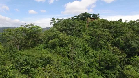 Pull back to close to pull back follow shot of person riding extreme zip Video stock 125978356