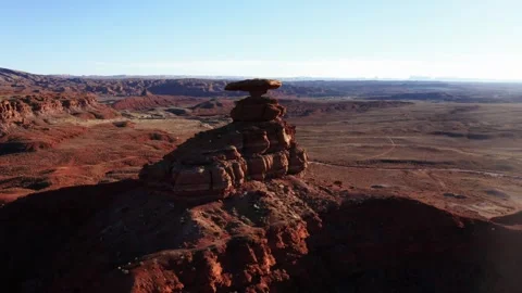 Pull back close to wide shot of Mexican Hat Rock in Utah near sunset. Stock Footage 336691716