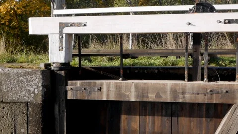 Pull back dolly shot showing the gate of a closed pound lock. Filmed in Video stock 118092992