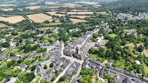 Pull back drone aerial reverse reveal Locronan medieval village Brittany France Stock Footage 340312747