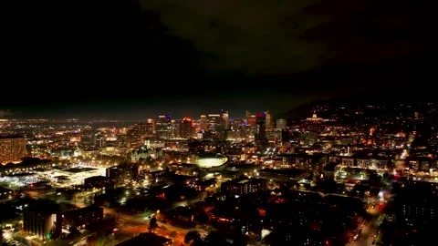 Pull back drone aerial shot of Salt Lake City at night with city lights Stock Footage 260455823