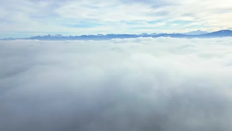 Pull back drone shot of sea of fog above the clouds with mountain Video stock 300938552