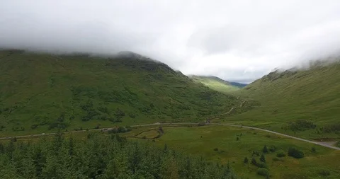 Pull Back Drone Shot of Soft Scottish Morning over Green Landscape 스톡 동영상 97592124