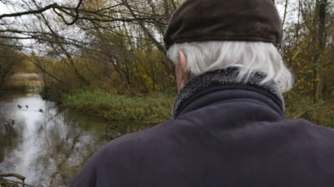 Pull Back Of Elderly Man Looking At View 4K Stock Footage 69984661