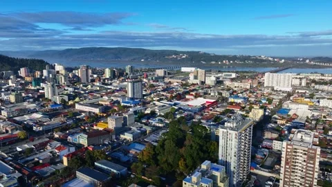 Pull back flight over Concepcion dense urban neighborhoods revealing city Stock Footage 336268538