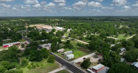 Pull back flight viewing a small community in rural Texas Stock Footage 335672745