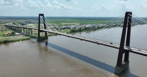 Pull back flight viewing the suspension bridge and flat land beyond Stock Footage 335671960