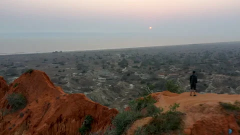 Pull back footage from a Man Standing Edge Cliff Stock Footage 149049418