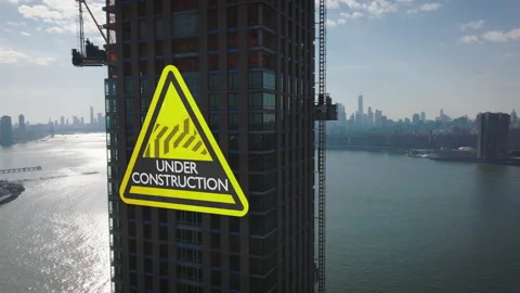 Pull back footage of modern high rise building on waterfront under construction Vidéo 198705646