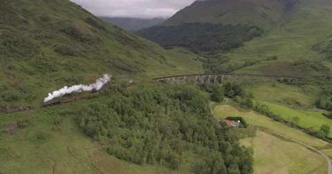 Pull back, high altitude aerial shot of the Jacobite Express after Video stock 169062540