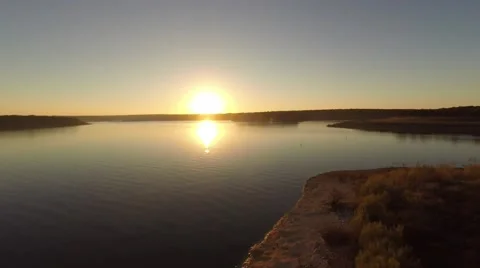 Pull back of lake at sunset Stockbeeldmateriaal 46730359