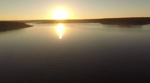 Pull back of lake at sunset from medium height Stockbeeldmateriaal 46730511