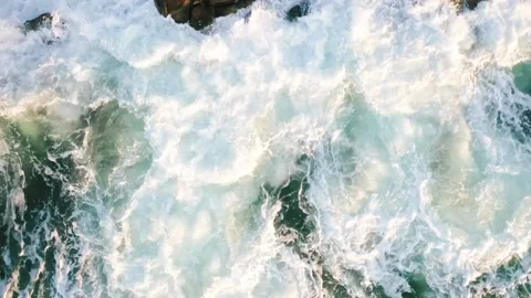 Pull Back Overhead Aerial Drone clip of Ocean Waves on rocky shore Stock Footage 143431211
