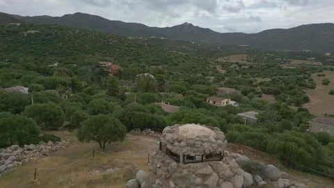 Pull back reveal of a beautiful Nuraghe in Sardinia and landscape Video stock 245547559