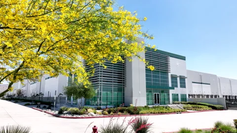 Pull Back Reverse Shot from Modern Industrial Commercial Warehouse Exterior Stock Footage 332673989