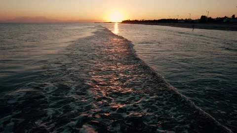 Pull back of sea waves on a summer sunset. Stock Footage 161084186