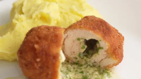 Pull Back shot of Halved Kiev Cutlet with Mashed Potatoes. Stock Footage 258651260