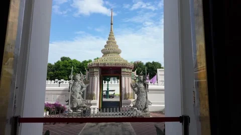 Pull-back shot from an ornamental gate through a window at Wat Phra in Bangkok. Stock Footage 303889533