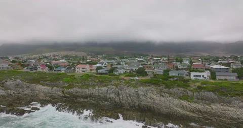 Pull back shot of people standing on coastal rocks and watching crashing waves Stock Footage 172151255