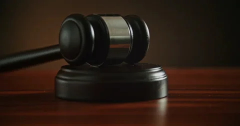 Pull back shot of Pounding Gavel on Block Stock Footage 57540365