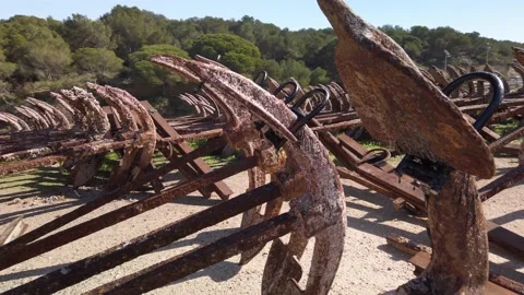 Pull Back Shot of rusty anchors stored in rows at port of Barbate, Cadiz, Stock Footage 137973527