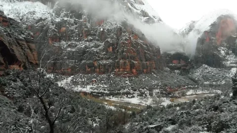 Pull Back shot of the snow covered mountain ridge line with clouds Video stock 289815232