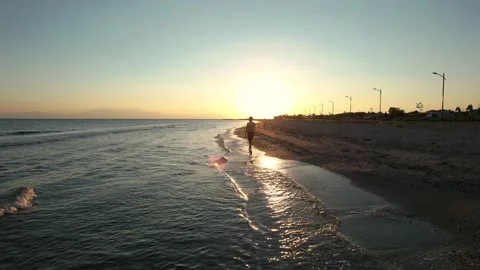 Pull back shot of young boy walking on the beach. Stock Footage 161084415