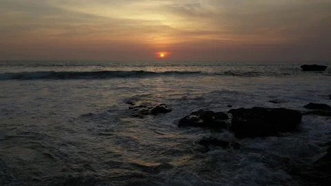 Pull back sunset small waves Stock Footage 120519061