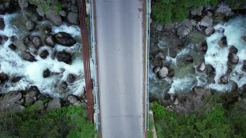 Pull back view of asphalt bridge in woods in Switzerland Stock Footage 201939338