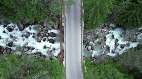Pull back view of asphalt bridge in woods in Switzerland Stock Footage 201940408