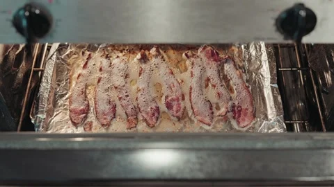Pull back view of bacon cooking Stock Footage 293947826