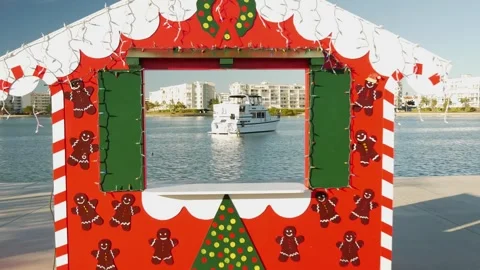 Pull back Wide Framed view through a red, white and green Christmas photo booth. Stock Footage 295009774