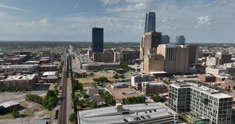 Pull descending viewing train moving alongside downtown Oklahoma City Stock Footage 335674242