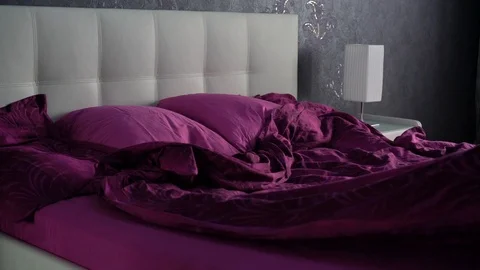 Pull down the violet blanket and cover it up over the bed 스톡 동영상 90095639
