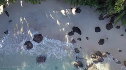 Pull up drone reveal footage, Drone footage of secluded beach at glacis Stock Footage 322892766