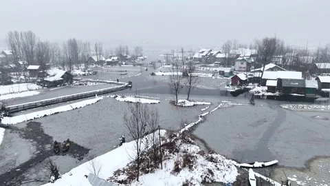 Pull-in drone shot flying over a snow covered heritage houses in the interiors Stock Footage 310223194