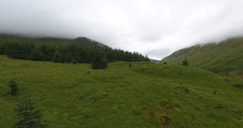 Pull Up Drone Shot with a Pine Forest and Low Clouds in Scotland 스톡 동영상 97592408