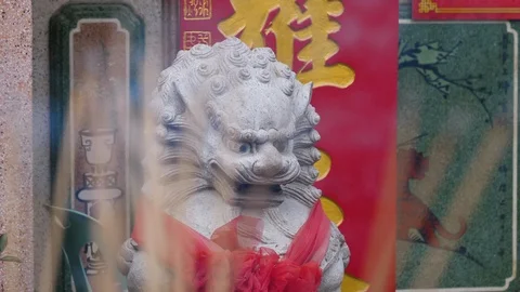 Pull Focus Between Chinese Stone Lion And Incense Sticks Stock Footage 124458611