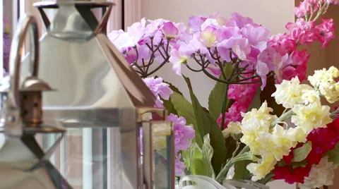 Pull focus between old fashioned antique lamp and flowers Stock Footage 35600117