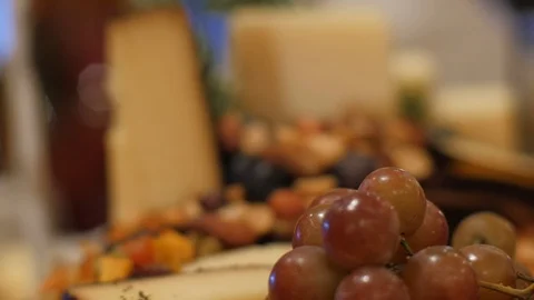 Pull focus on cheese platter with fruit and nuts Stock Footage 107393422