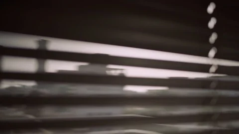 Pull focus from city outside to window blinds - camera is indoors Stock Footage 109164233