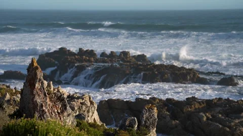 Pull focus, footage of Atlantic Ocean waves breaking onto rocks. Stock Footage 306839420