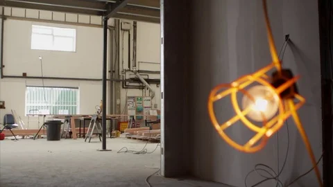 Pull focus from an industrial light to background building site 스톡 동영상 78767866