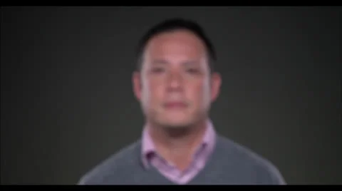 Pull focus man looking into lens Stock Footage 22487348